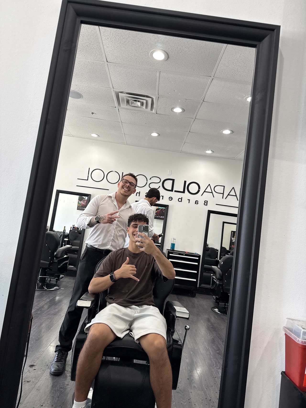 Barbers and a client inside JAPA OLD SCHOOL BARBERSHOP